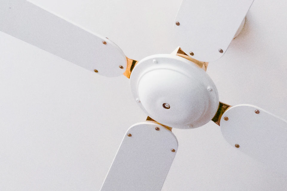 Ceiling fan blades and mounting bracket viewed from below during install